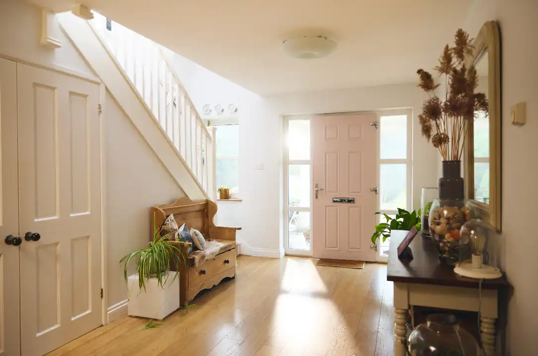 Bright white and cream hallway with front door in a modern home