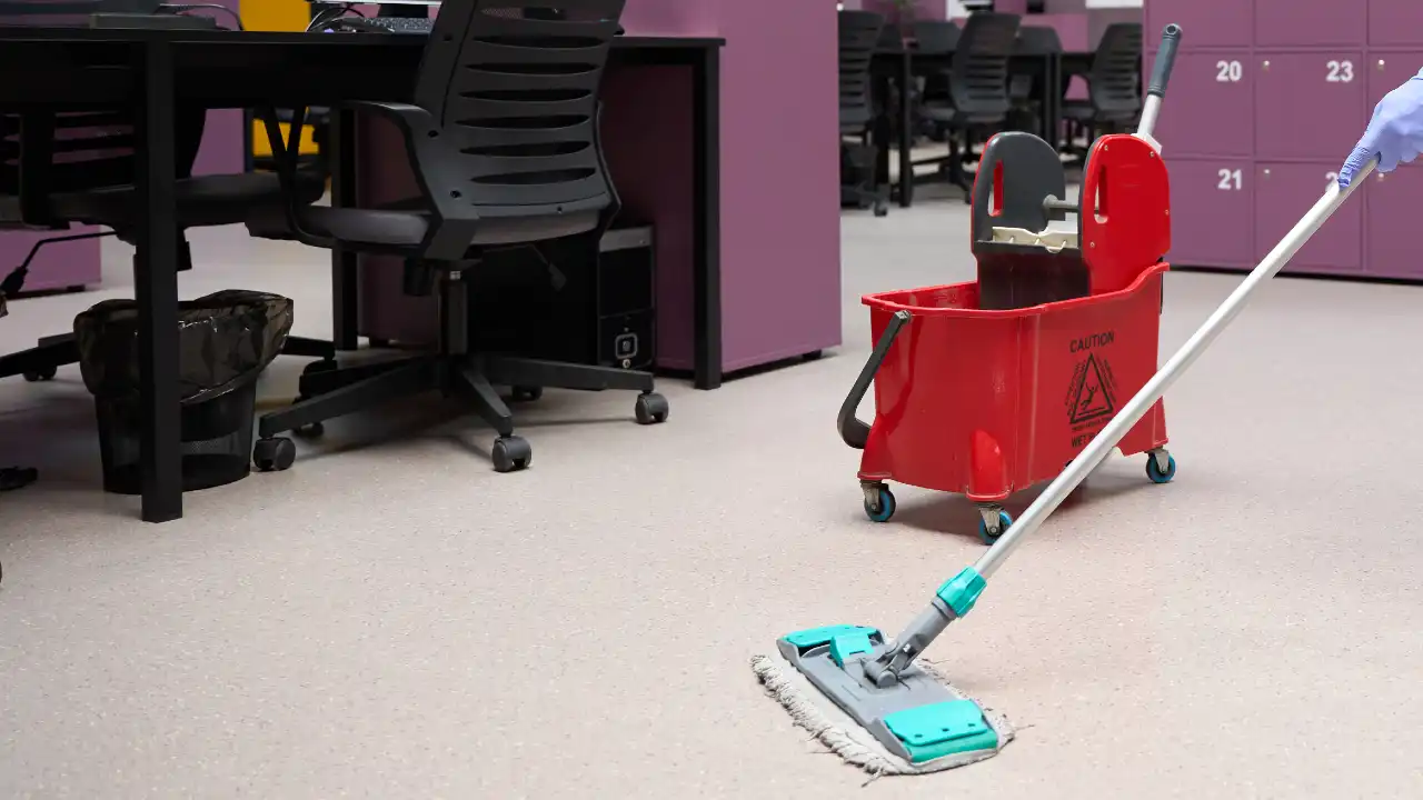 Cleaner tidying a modern coworking office space